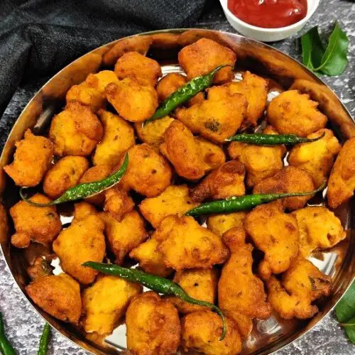 Moong Dal Pakoda | Moong Dal Vada | Moong Dal Bhajiya Recipe https://thespicycafe.com/wp-content/uploads/2023/07/11-1-moong-dal-pakoda-monsoon-snack-moong-bhajiya-moong-bhajji-bhajee-yellow-mung-bean-fritters-vegan-vegetarian-protein-rich-easy-quick-simple-breakfast-lunch-dinner.png https://thespicycafe.com/moong-dal-pakoda-recipe/