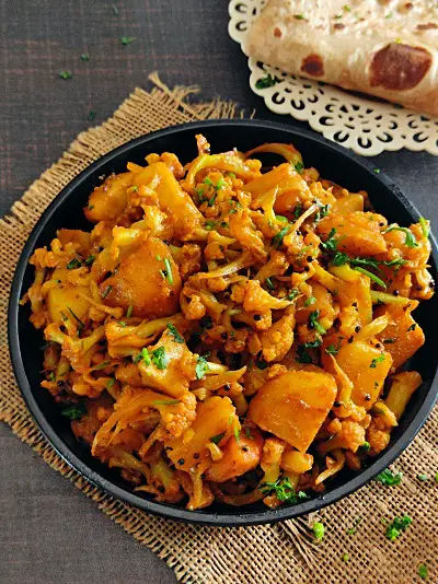 Flower Batata Sukhi Bhaji | Aloo Gobi Maharashtrian Recipe https://thespicycafe.com/wp-content/uploads/2023/02/2-maharashtrian-flower-batata-sukhi-bhaji-rassa-aloo-gobi-cauliflower-potato-curry-Indian-easy-simple-vegan-vegetarian-lunch-dinner-recipe.jpg https://thespicycafe.com/flower-batata-bhaji-maharashtrian-recipe/
