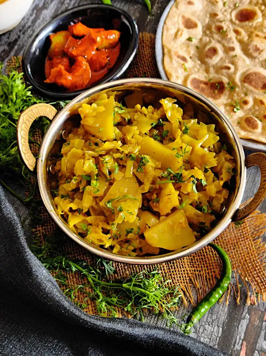 Kobi Batata Bhaji (Cabbage Potato Sabzi) https://thespicycafe.com/wp-content/uploads/2023/03/16-patta-gobi-ki-sabji-cabbage-potato-curry-kobi-chi-bhaji-vegan-vegetarian-easy-lunch-dinner-breakfast-sabzi-indian-recipes-maharashtrian.jpg https://thespicycafe.com/cabbage-potato-recipe/