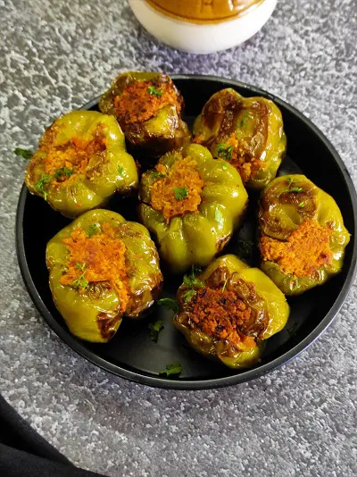 Bharli Dhobli Mirchi | Bharwa Shimla Mirch With Besan | Stuffed Capsicum Without Potatoes https://thespicycafe.com/wp-content/uploads/2023/08/1-bharwa-shimla-mirch-besan-shimla-stuffed-capsicum-vegan-vegetarian-protein-rich-side-dish-Indian-snack-easy-quick-simple-lunch-dinner.png https://thespicycafe.com/stuffed-capsicum-recipe/