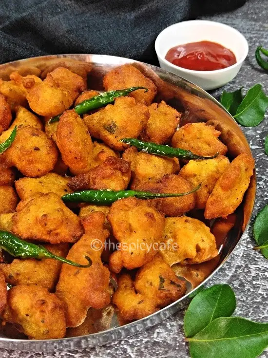 Moong Dal Pakoda | Moong Dal Vada | Moong Dal Bhajiya Recipe https://thespicycafe.com/wp-content/uploads/2023/07/11-1-moong-dal-pakoda-monsoon-snack-moong-bhajiya-moong-bhajji-bhajee-yellow-mung-bean-fritters-vegan-vegetarian-protein-rich-easy-quick-simple-breakfast-lunch-dinner.png https://thespicycafe.com/moong-dal-pakoda-recipe/