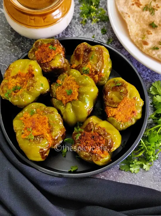 Bharli Dhobli Mirchi | Bharwa Shimla Mirch With Besan | Stuffed Capsicum Without Potatoes https://thespicycafe.com/wp-content/uploads/2023/08/1-bharwa-shimla-mirch-besan-shimla-stuffed-capsicum-vegan-vegetarian-protein-rich-side-dish-Indian-snack-easy-quick-simple-lunch-dinner.png https://thespicycafe.com/stuffed-capsicum-recipe/