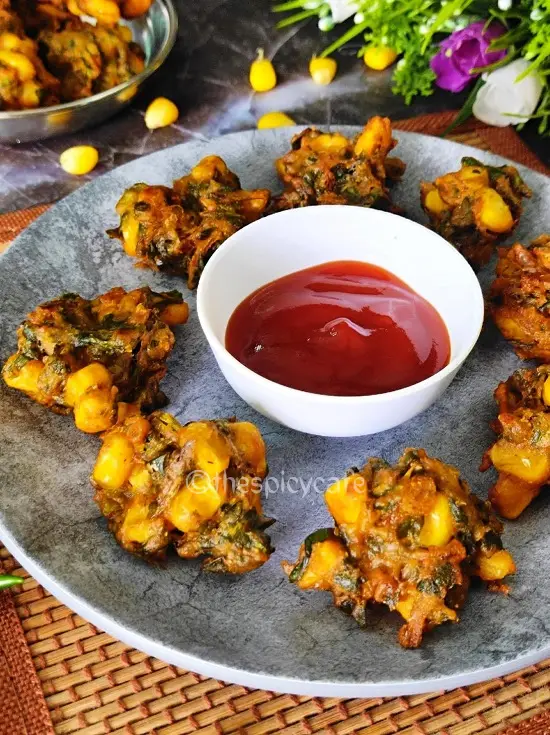 Corn Palak Pakoda | Spinach Corn Fritters | कुरकुरे पालक और कॉर्न के पकोड़े https://thespicycafe.com/wp-content/uploads/2023/09/1-corn-palak-pakoda-spinach-fritters-vegan-vegetarian-delicious-easy-quick-simple-Indian-deep-fried-snack-recipe-lunch-dinner-party-appetizer.png https://thespicycafe.com/corn-palak-pakoda/