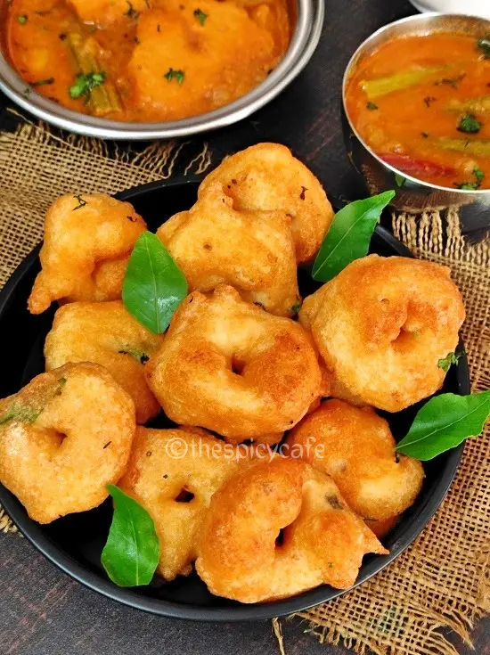 Medu Vada Recipe | Urad Dal Vada https://thespicycafe.com/wp-content/uploads/2023/04/1-medu-vada-south-indian-ulundu-uddina-geralu-uzhunnu-urad-dal-vada-breakfast-snack-vegan-vegetarian-easy-quick-simple-Indian-snack-recipe.jpg https://thespicycafe.com/medu-vada-recipe/