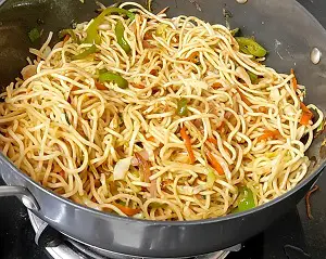 Hakka Noodles Recipe | Vegetable Hakka Noodles | व्हेज हक्का नूडल्स https://thespicycafe.com/wp-content/uploads/2023/10/1-hakka-noodles-vegetable-chinese-noodles-street-food-snack-Indo-Chinese-easy-quick-simple-lunch-dinner-brunch-vegan-vegetarian-thespicycafe.png https://thespicycafe.com/chinese-vegetable-hakka-noodles/