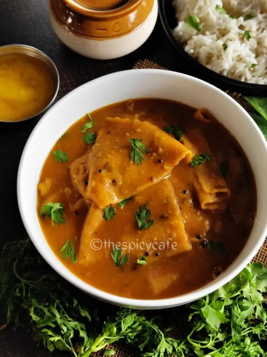 Varanfal / Chakolya - Dal Dhokli Recipe https://thespicycafe.com/wp-content/uploads/2023/01/traditional-gujarati-dal-dhokli-recipe-authentic-maharashtrian-varanfal-recipe-vegan-vegetarian.jpg https://thespicycafe.com/daldhokli-varanfal-recipe/